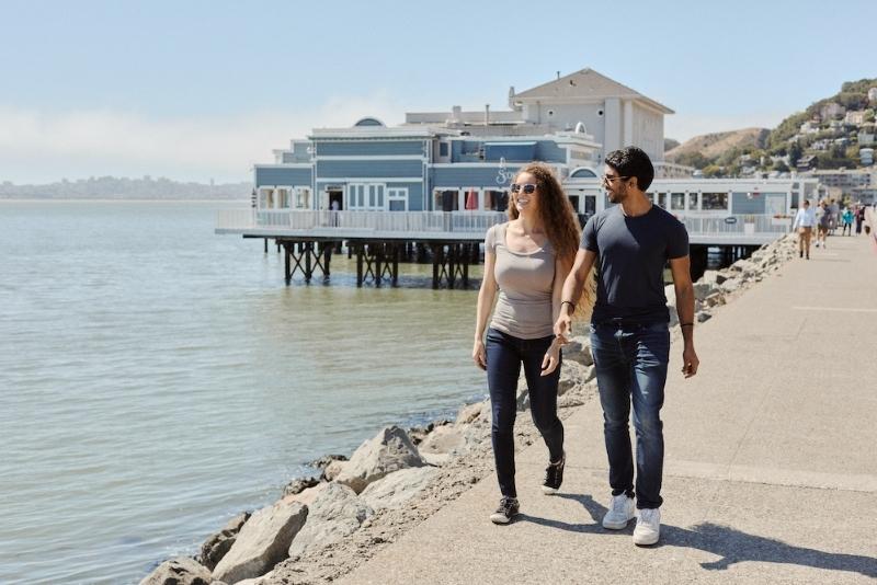 Couple walking in Sausalito along the waterfront: San Francisco Date Idea!