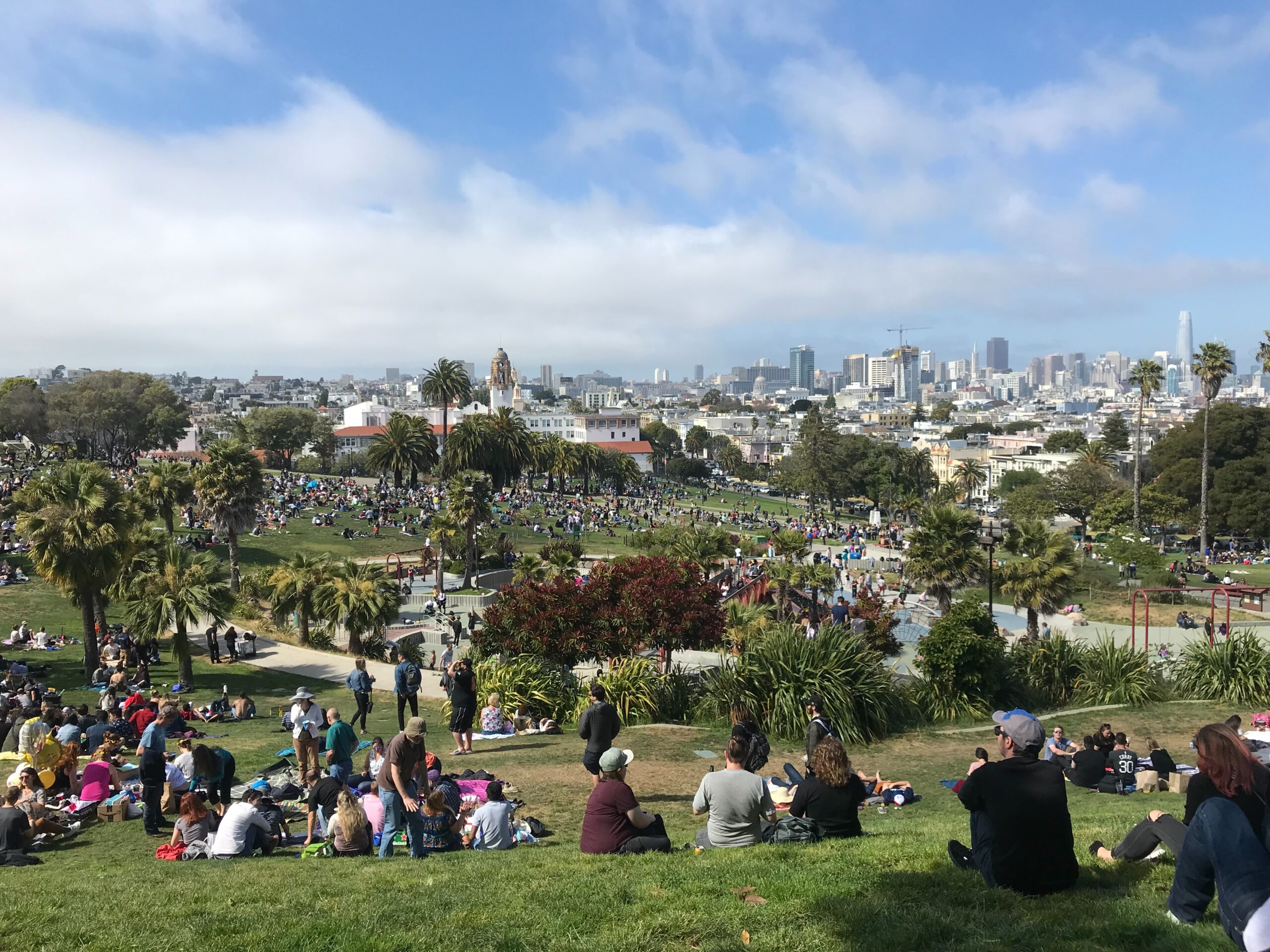 People hanging out with a view of Mission Dolores Park, San Francisco