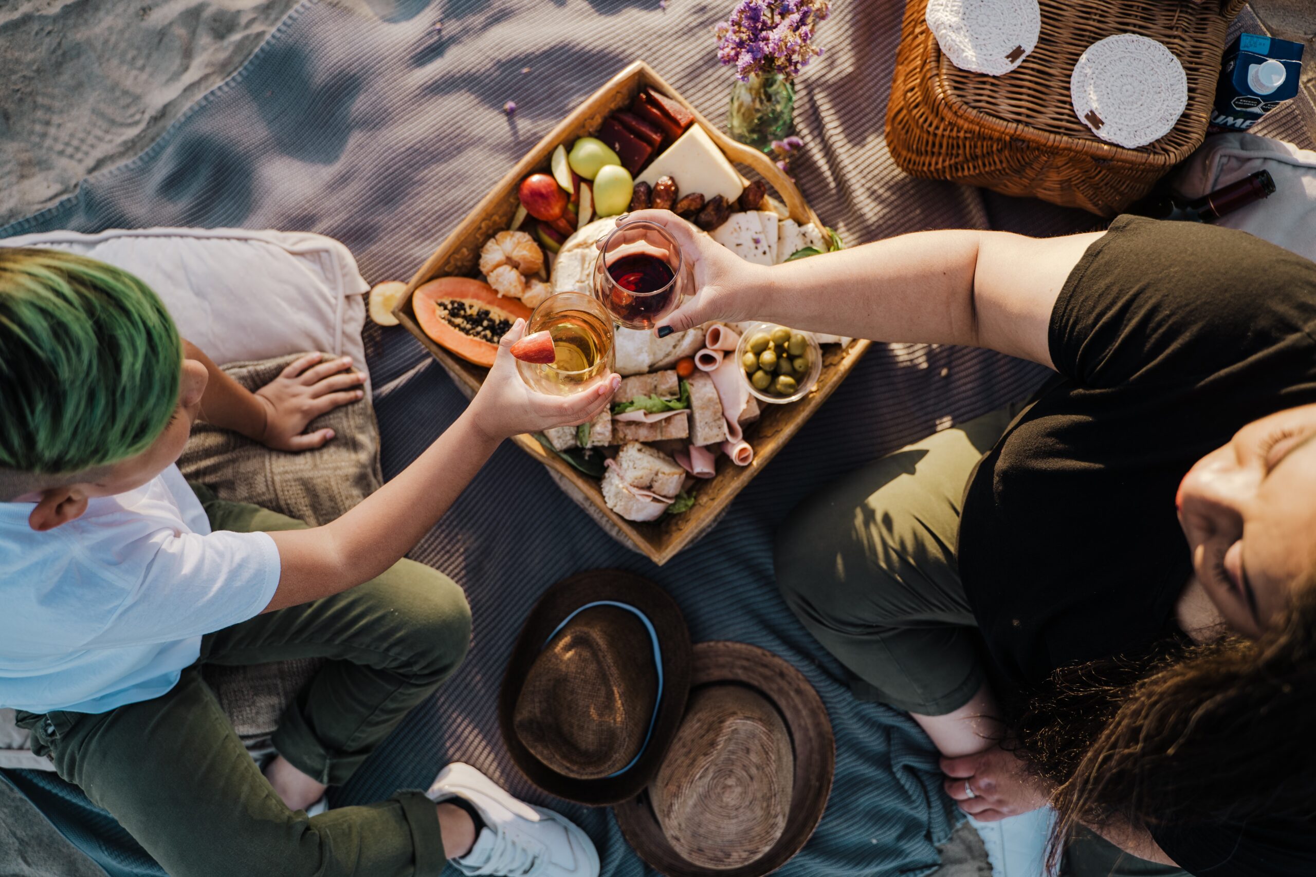 Couple having a picnic date with wine and cheese